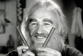 Gene Hackman holding two sticks and smiling in Young Frankenstein