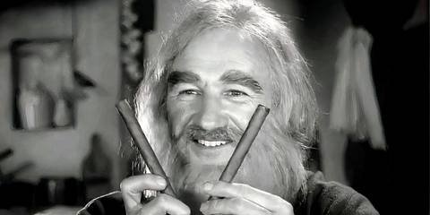 Gene Hackman holding two sticks and smiling in Young Frankenstein