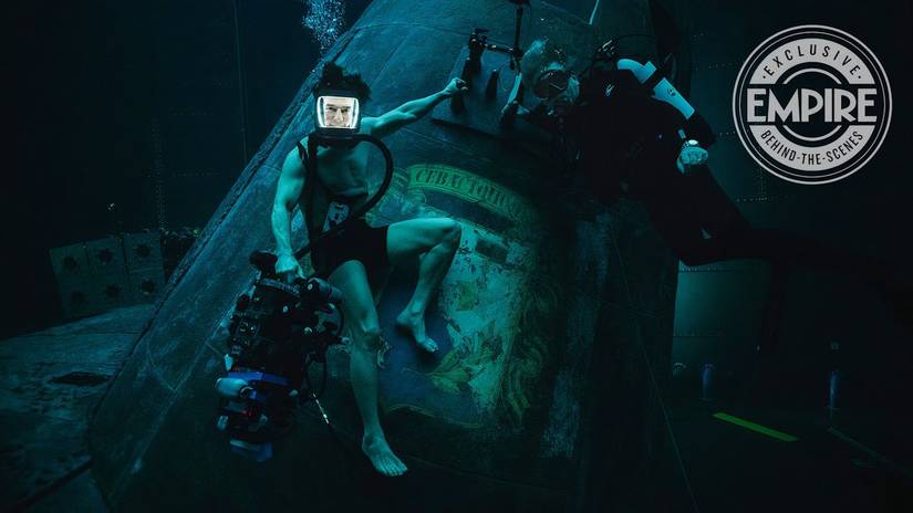 A behind the scenes image of Tom Cruise hanging onto a submarine while filming Mission Impossible The Final Reckoning