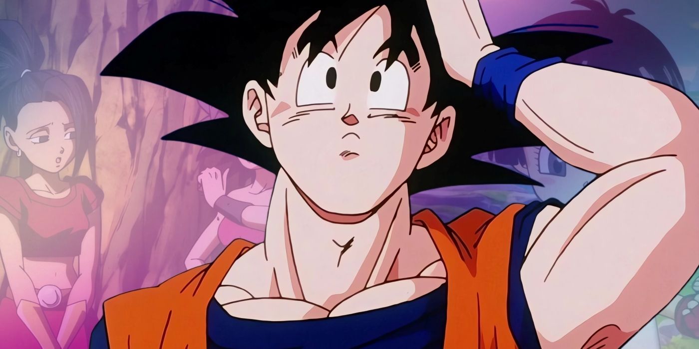 Goku looking confused while holding his head. Behind him, some of the female Saiyan characters can be seen.