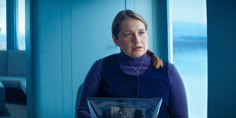 Merritt Wever looking worried, sitting in the Outie visitation suite as Gretchen in Severance season 2, episode 6 (2025)
