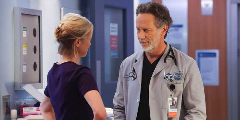 Chicago Med Hannah and Dean staring at each other with a mixture of hostility and love