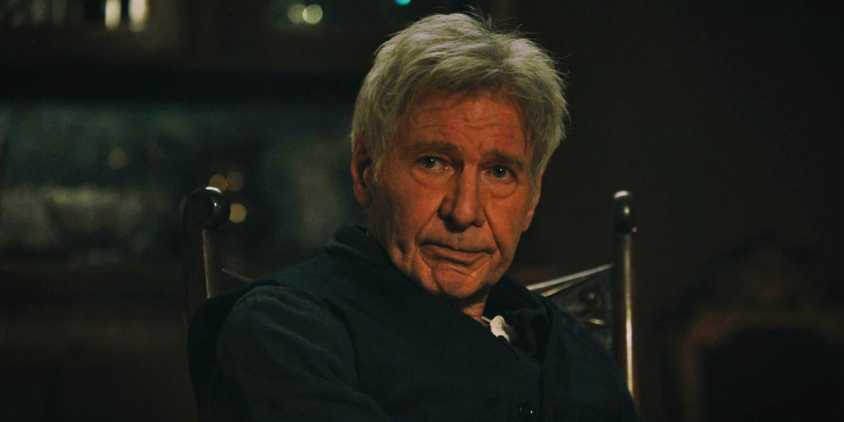 Harrison Ford sits in a chair wearing a thoughtful expression in a scene from 1923