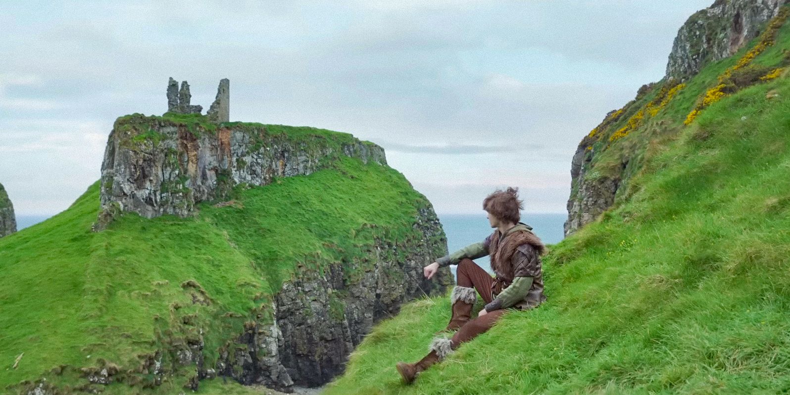 Hiccup (Mason Thames) on the Isle of Berk, pensively contemplating the landscape in How To Train Your Dragon (2025)