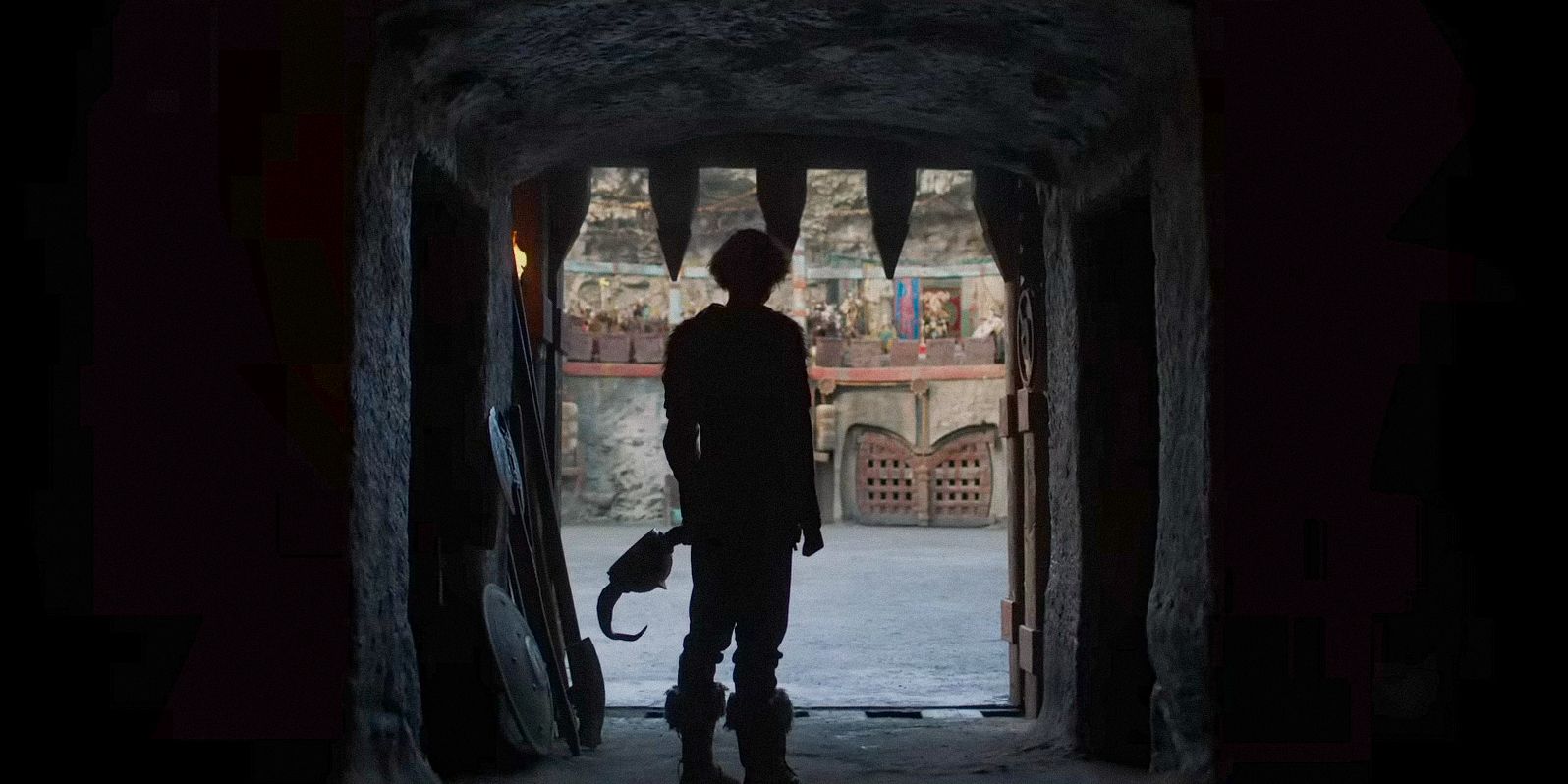 The silhouette of Hiccup before he goes out to the arena to fight against dragons in How To Train Your Dragon (2025)