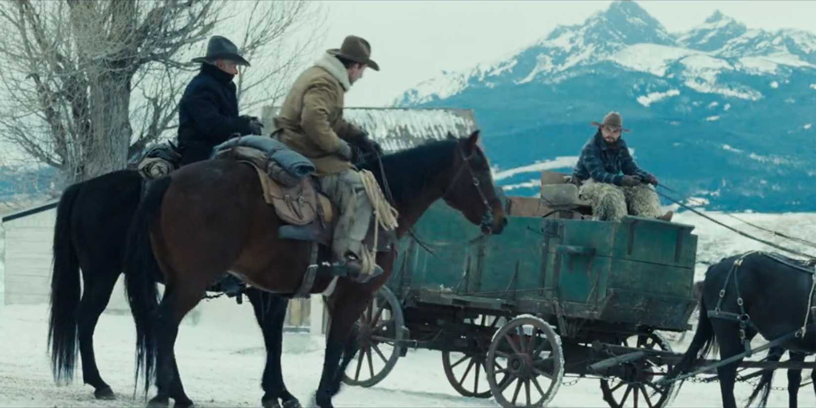 Jack drives a green wagon as cowboys look on in 1923