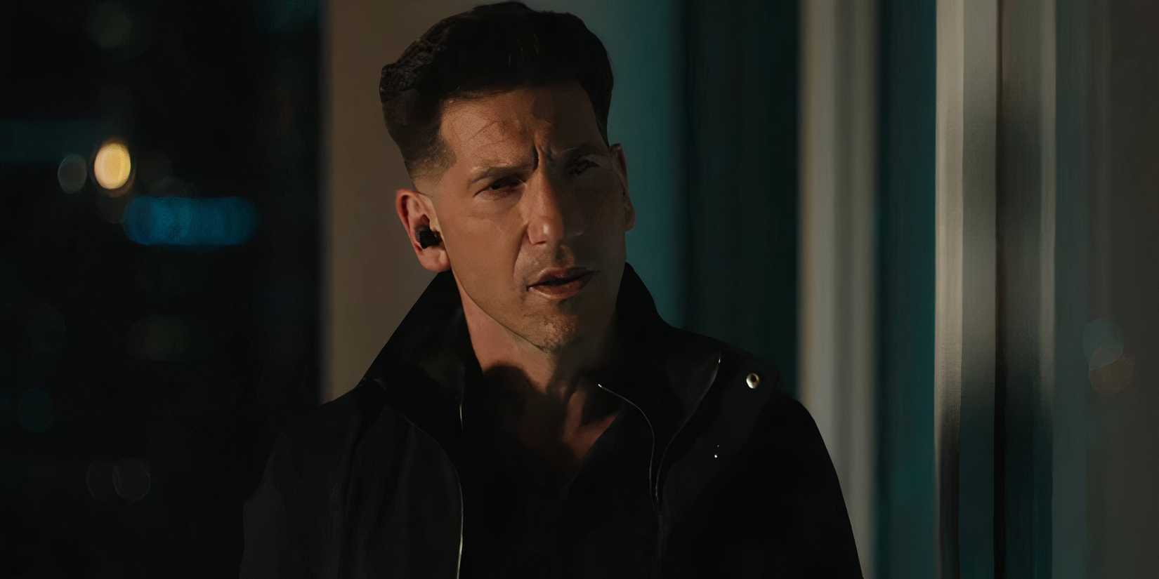 Jon Bernthal as Brax looking confused while looking out of a window in The Accountant 2