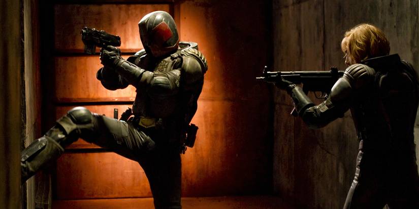 Judge Dredd kicks down a door next to Judge Anderson in Dredd