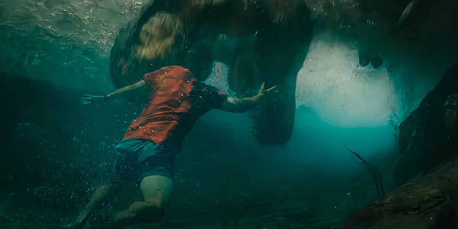 A person swimming away from a T-Rex's open mouth in Jurᴀssic World Rebirth