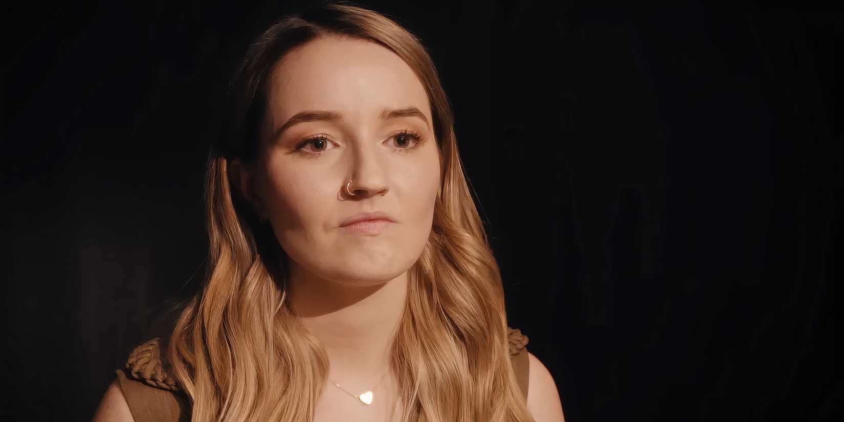 Kaitlyn Dever as Belle looking tense during an interrogation in Apple Cider Vinegar