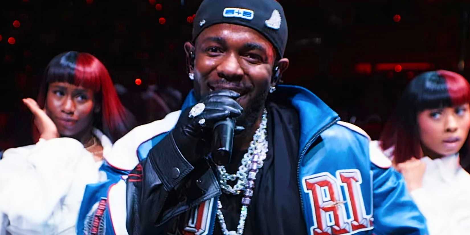 Kendrick Lamar smiles at the camera during his Super Bowl half time show