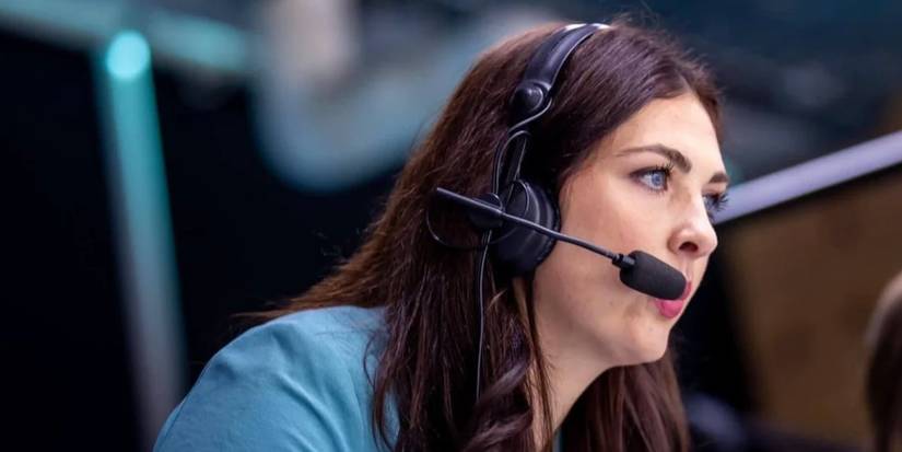 Kenzie Lalonde on a headset while announcing a sporting event