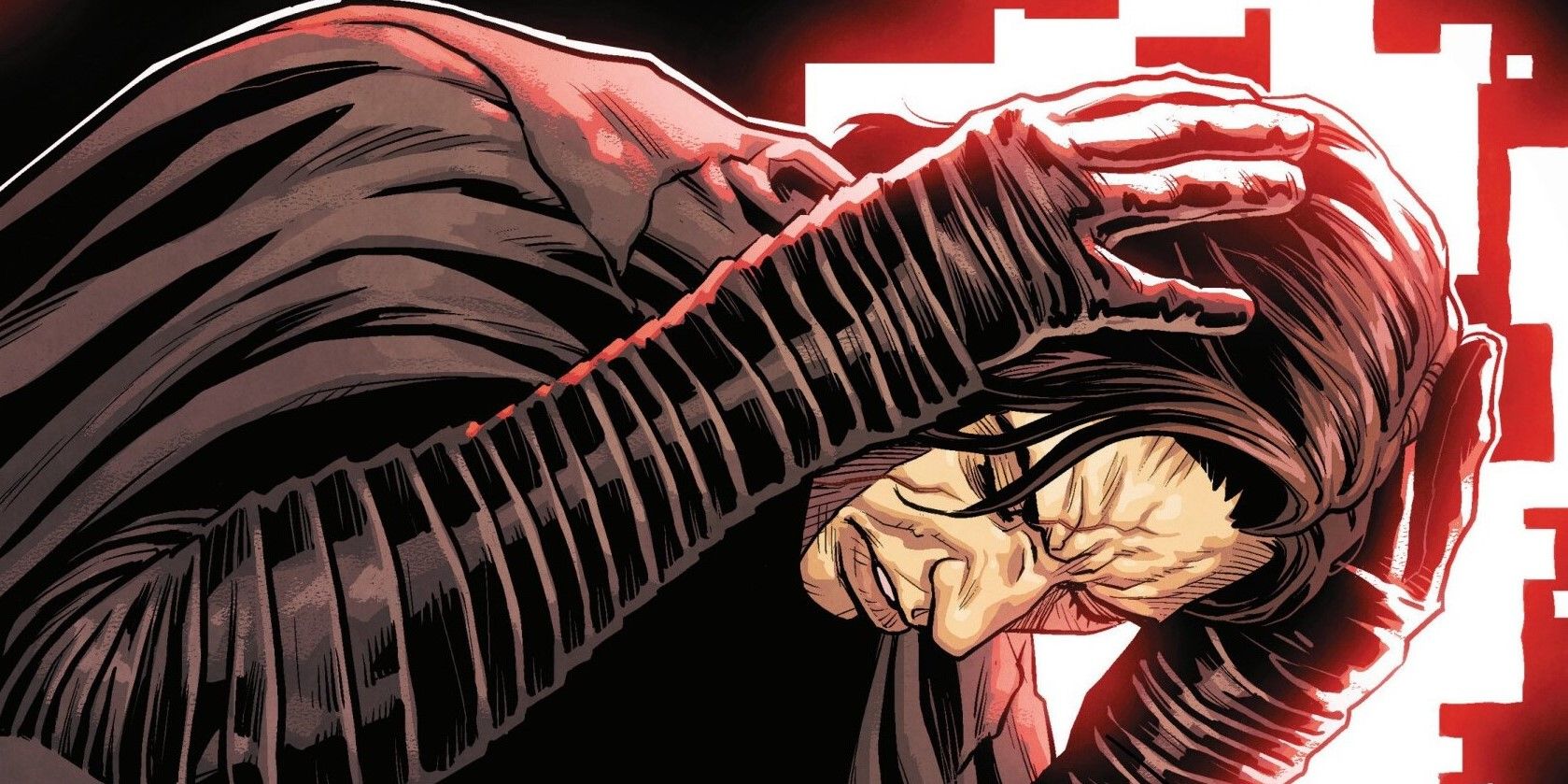 Kylo Ren holds his head in pain.