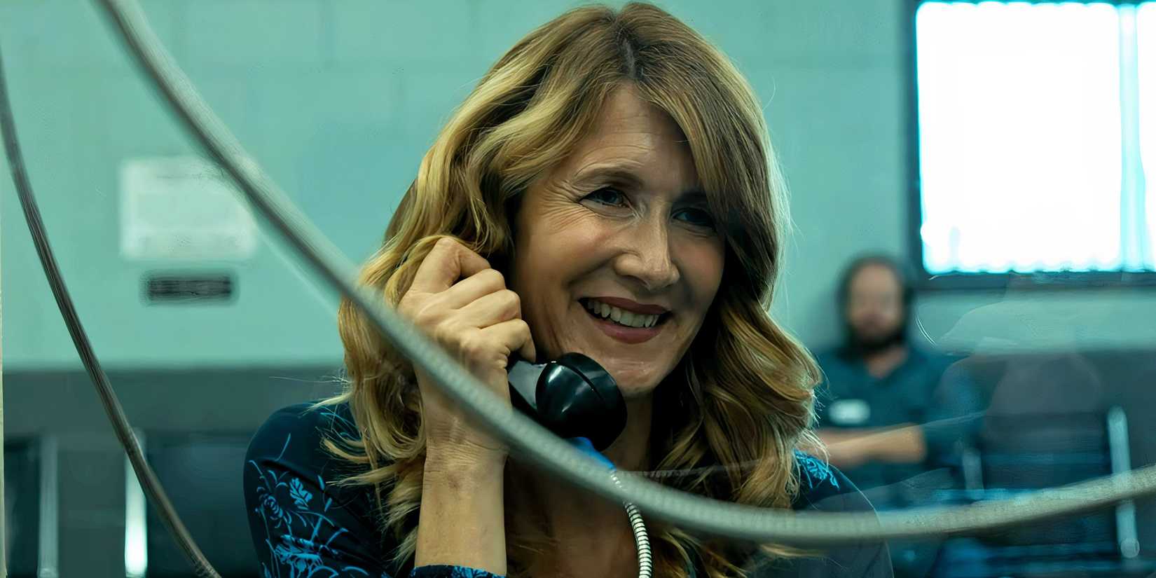 Laura Dern speaking with a prisoner across the glᴀss in Trial by Fire