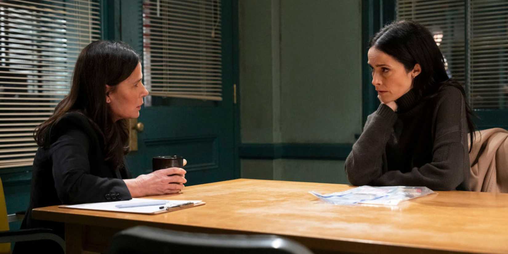 Law & Order Brady sitting across from Michelle at a table in the police station