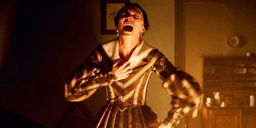 Lily Rose Depp grabbing at her dress and screaming in Nosferatu