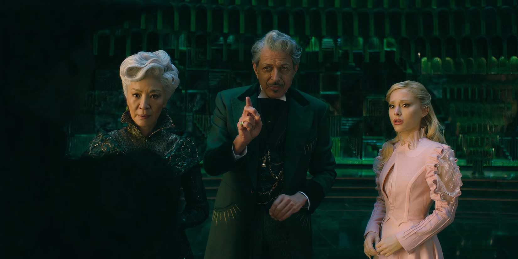 Madame Morrible stands with the Wizard and Glinda in Wicked