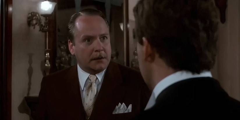 Martin Mull as Colonel Mustard talking to Tim Curry as Wadsworth in Clue
