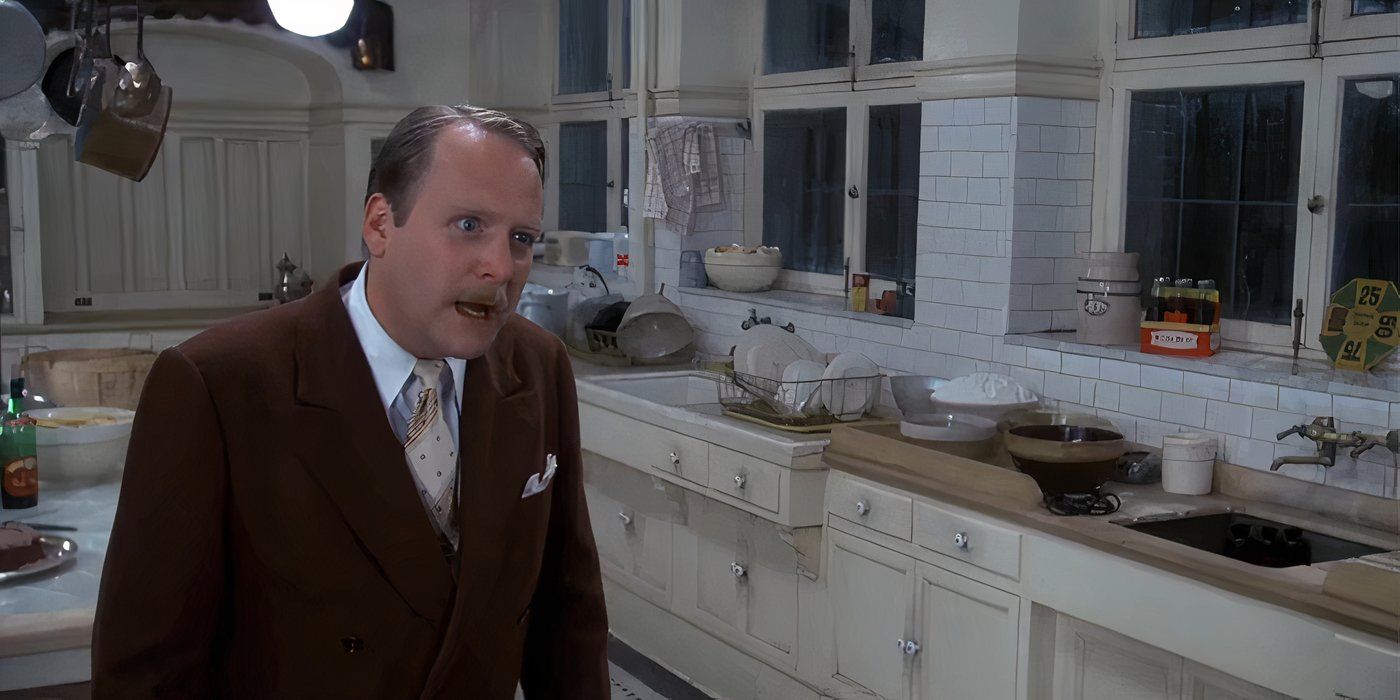 Martin Mull as Colonel Mustard threatens Miss Scarlett in the kitchen in Clue