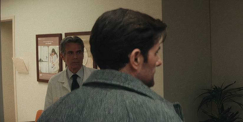 Dr. Mauer secretly looking at Gemma over Mark's shoulder in a fertility clinic in Severance season 2 (2025)