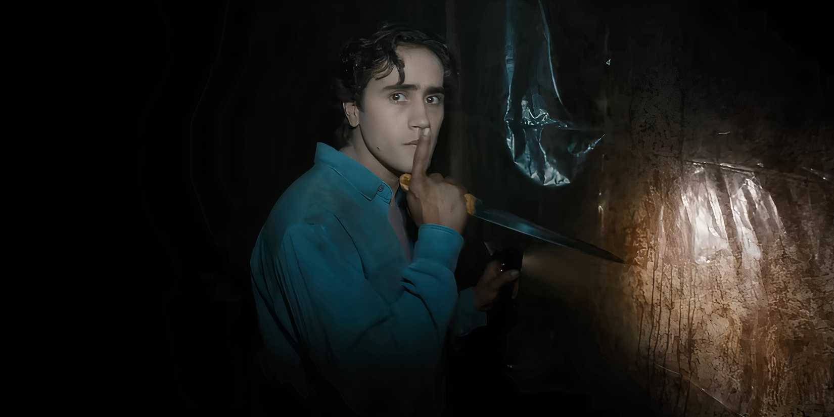 Michael Cimino's Max making a shush motion while holding a knife in Until Dawn