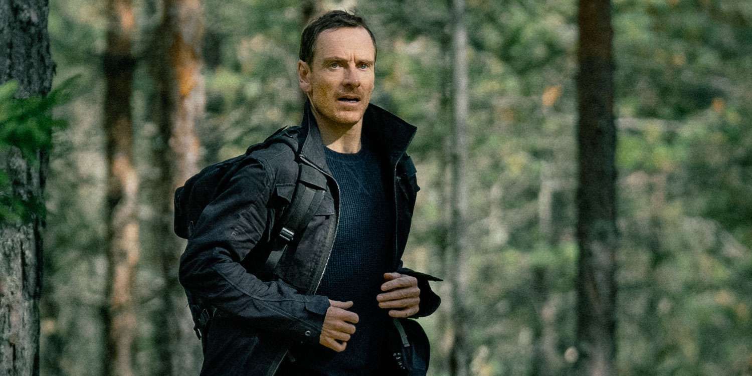 Michael Fassbender running through the forest in The Agency