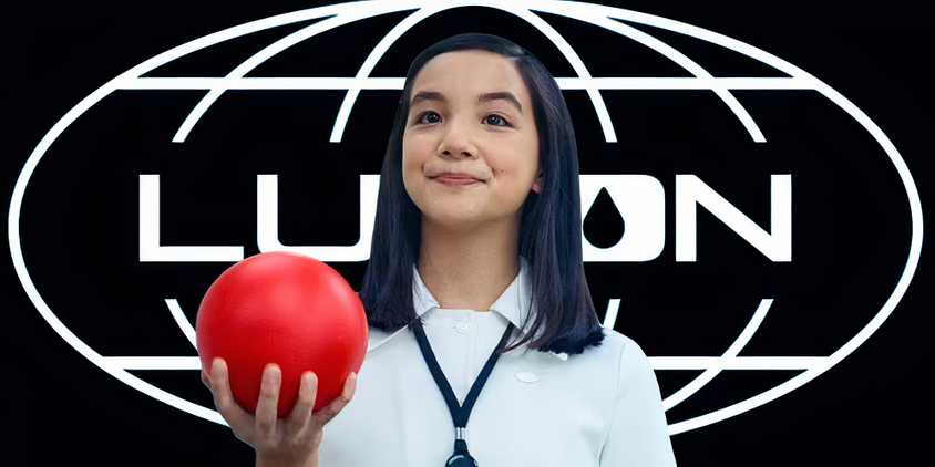 Miss Huang holding a red ball in Severance season 2 (2025) above a Lumon logo