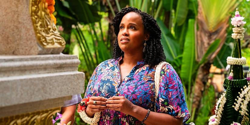 Natasha Rothwell looks up hopefully at the White Lotus Hotel in season 3