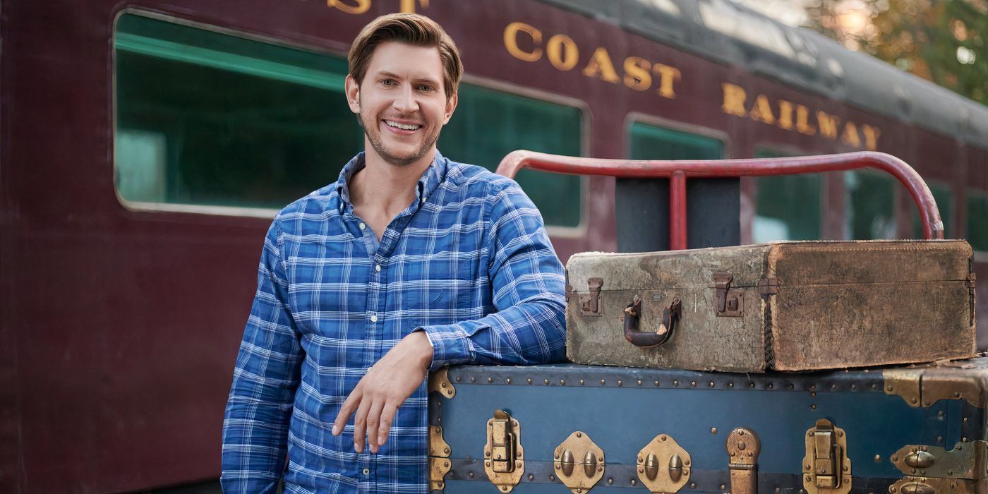 Greyston Holt smiles while leaning against a luggage cart in Cross Country Christmas