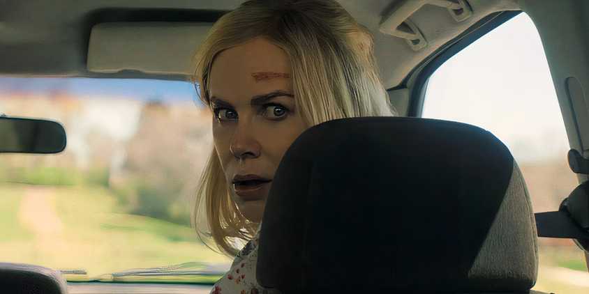 Nicole Kidman as Nancy looking scared over her shoulder and car seat in Holland