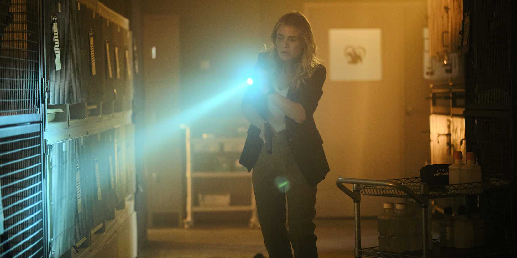 Melissa Roxburgh as Rebecca Henderson holding a flashlight in The Hunting Party season 1, episode 1