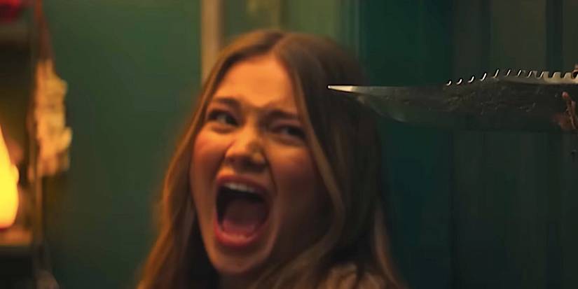 Olivia Holt as Ally screams beside a knife in Heart Eyes