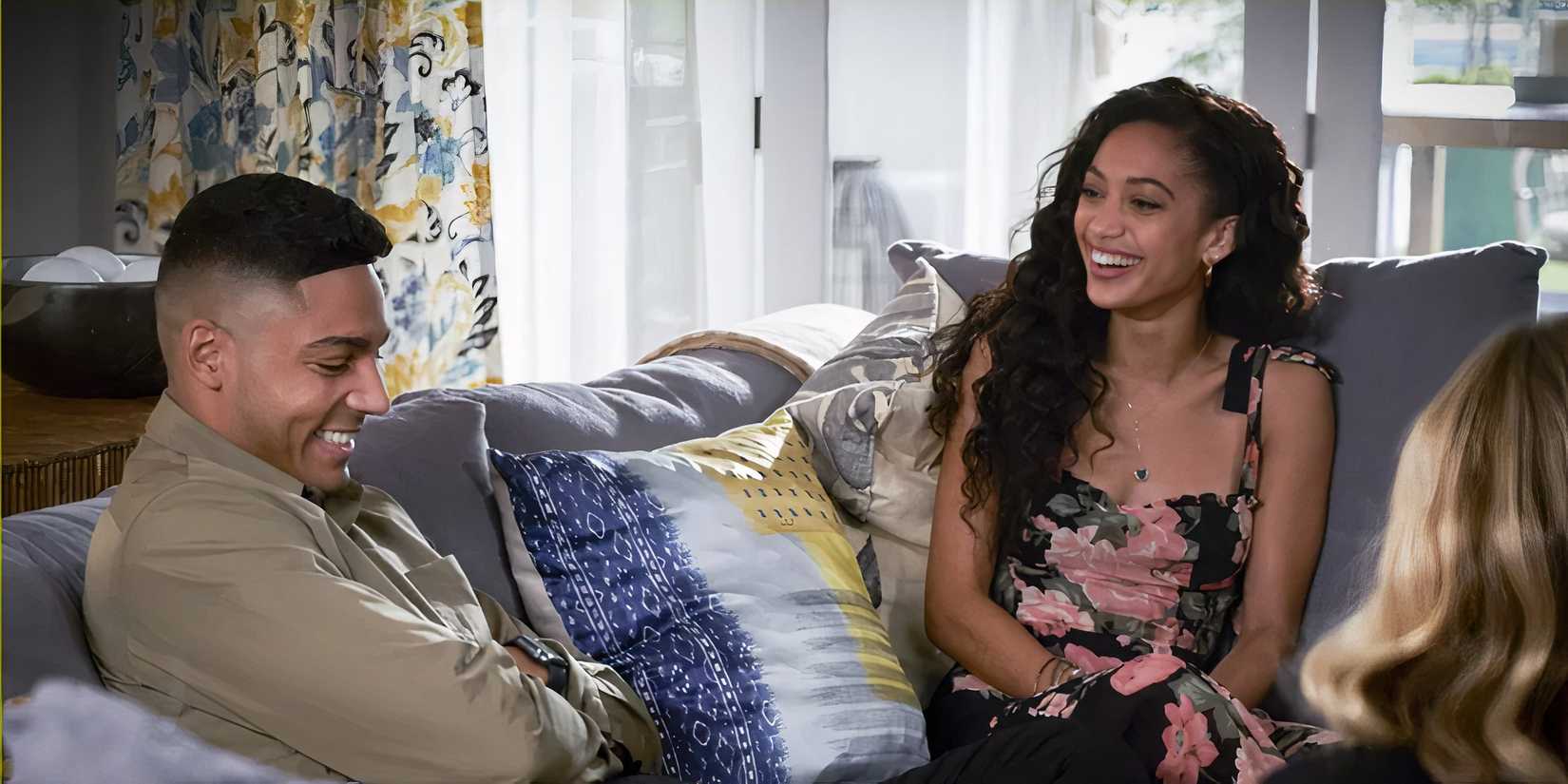 Olivia sitting on a couch laughing on All-American