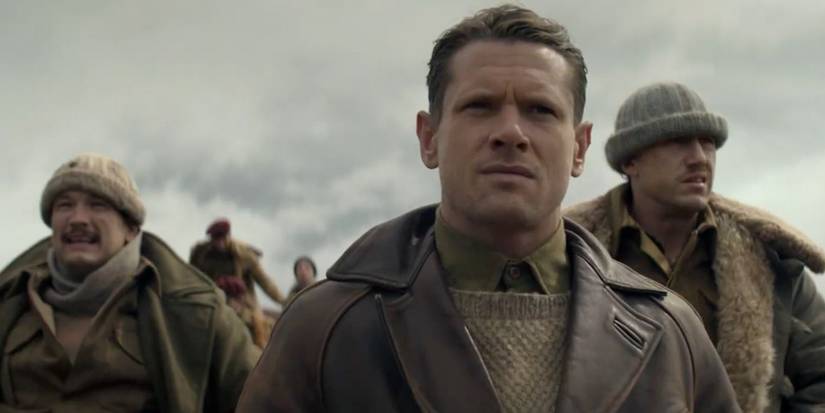 Paddy Mayne (Jack O'Connell) looking concerned with two soldiers behind him in SAS Rogue Heroes.