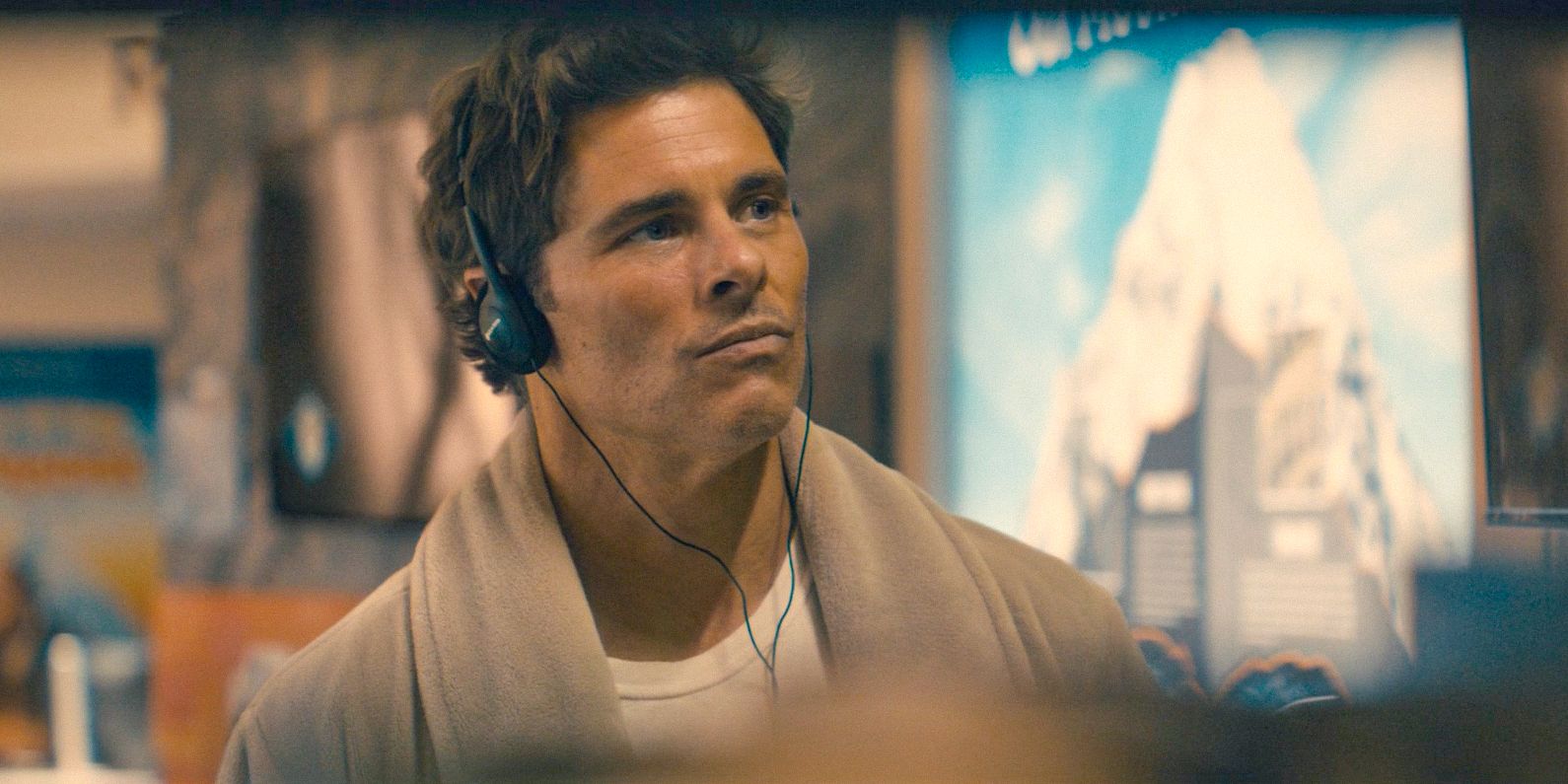 Cal (James Marsden) wearing his headphones while visiting the library in Paradise (2025) Season 1 Ep 5