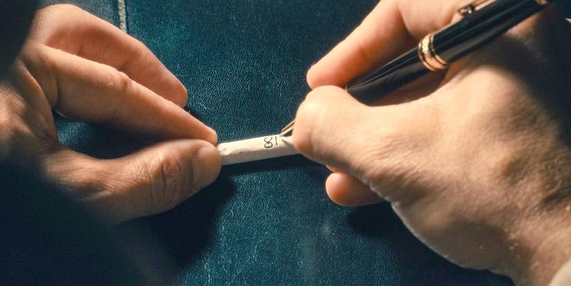 Cal writes a series of numbers on a cigarette in Paradise (2025) Season 1 Ep 5