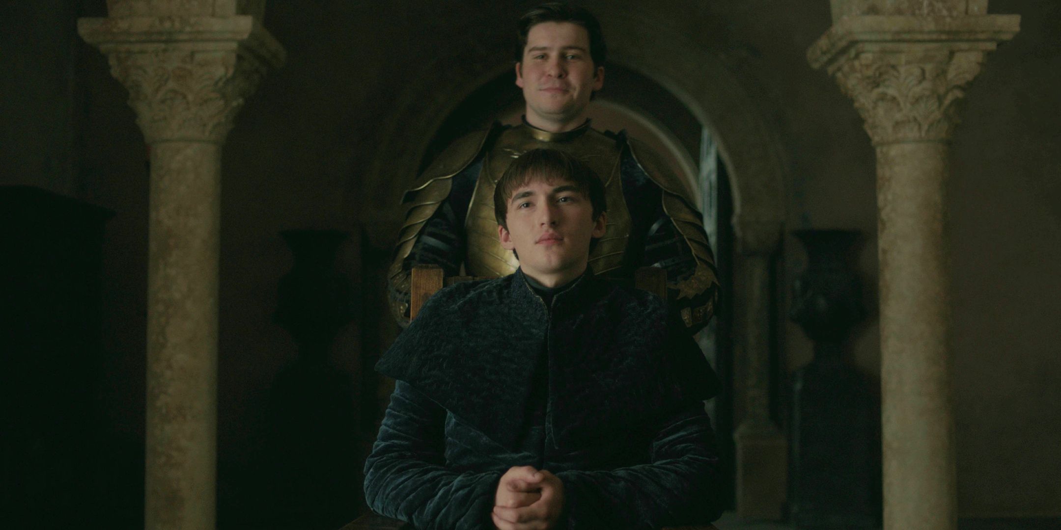 Podrick Payne in Kingsguard armor standing behind King Bran Stark in Game of Thrones season 8, episode 6