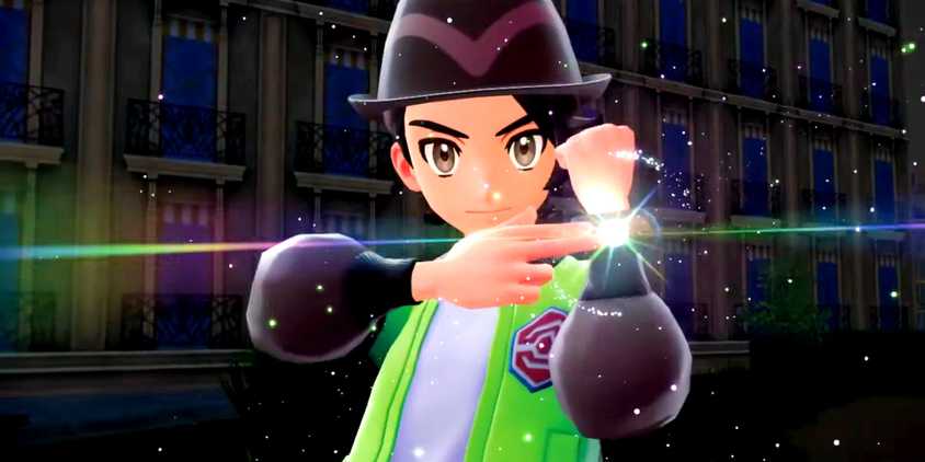 Pokemon legends za player holding up his arm and pointing to a device on his wrist that shines