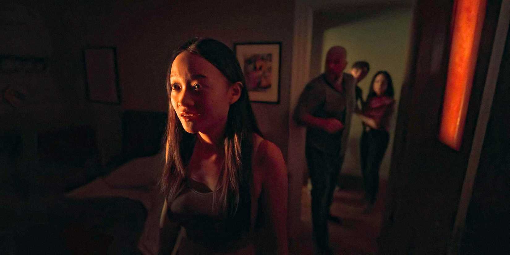 Chloe (Callina Liang) stands frozen while her family tries to help her in Presence