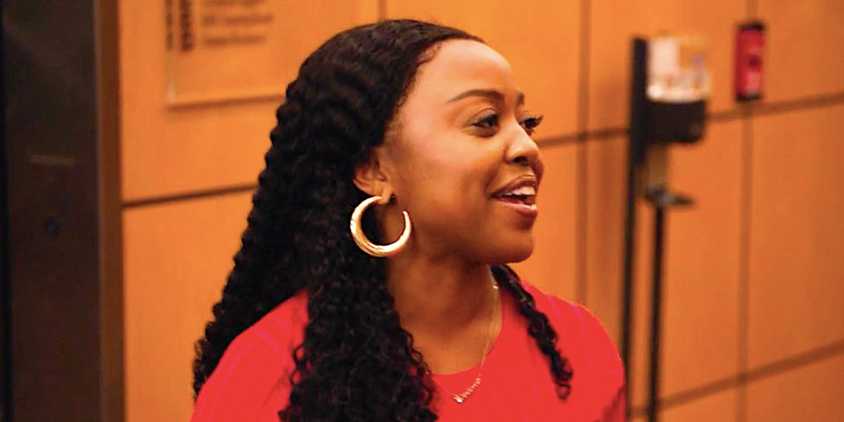 Quinta Brunson's Janine laughing in a hallway in Abbott Elementary