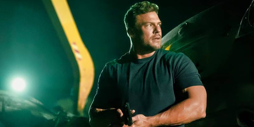 Reacher holding a gun and looking nervous in Reacher season 3