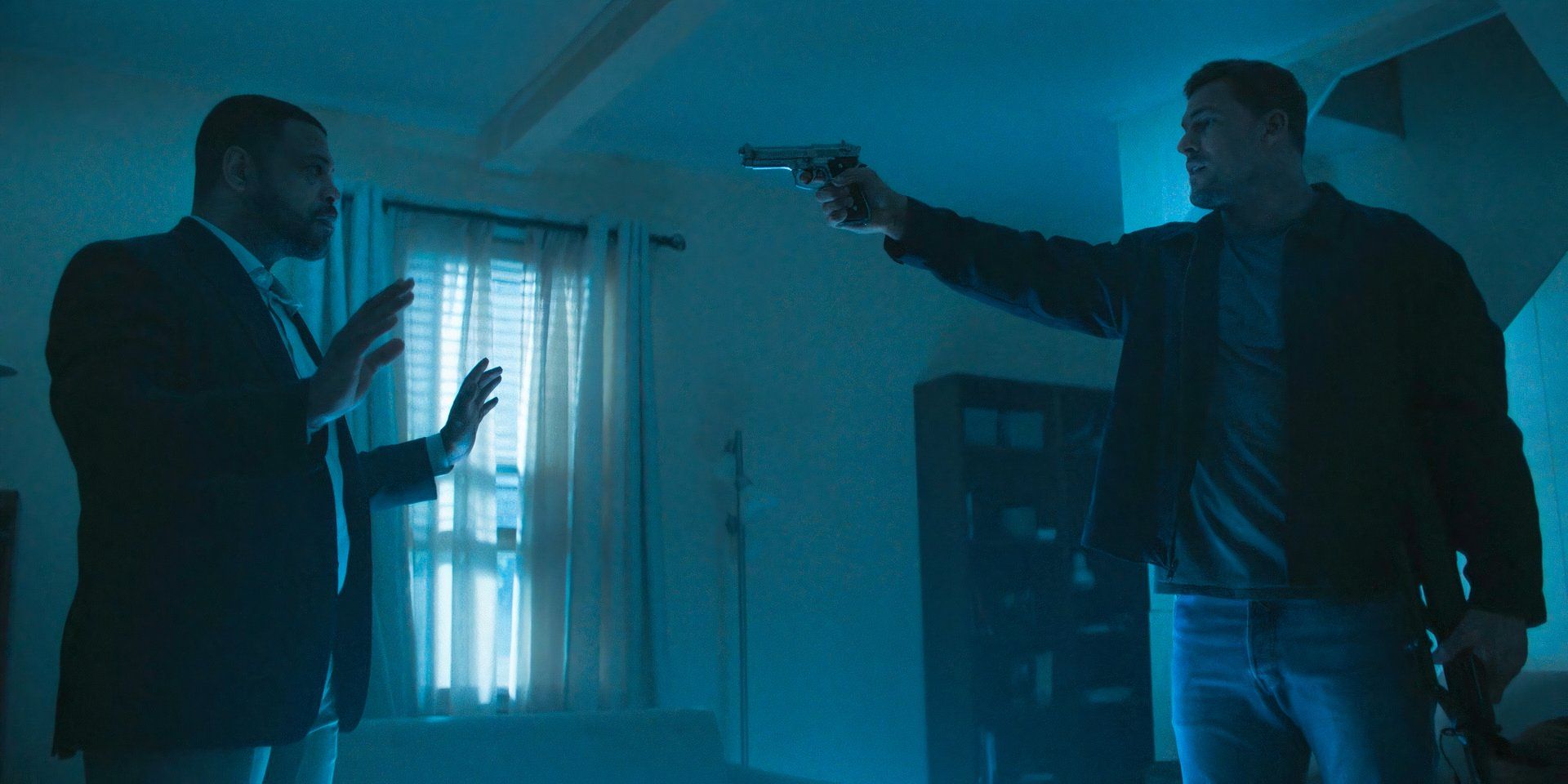 Reacher (Alan Ritchson) pointing a gun at Chapman Duke (Donald Sales) in Reacher season 3