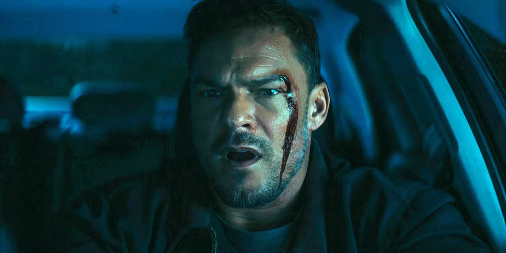 Alan Ritchson as Reacher looking surprised with blood on his face in Reacher season 3, episode 3