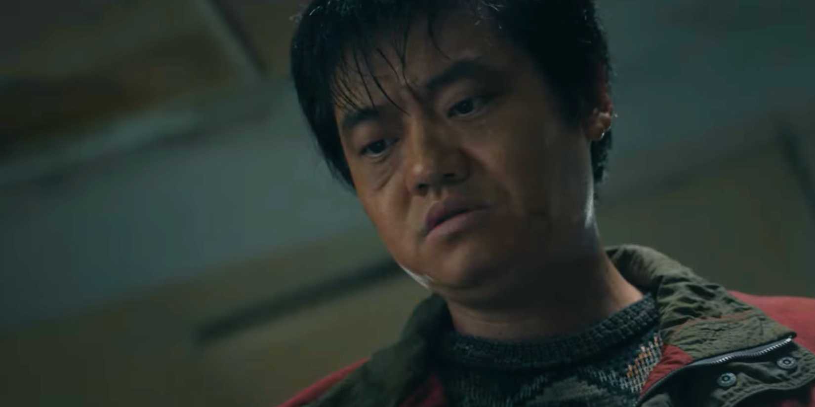 Revelations actor looking down, with a blank expression on his face