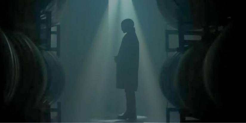 The Heart Eyes Killer standing in a beam of light in Heart Eyes