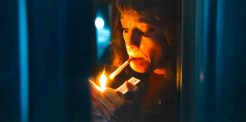 Character in September 5 lighting a cigarette
