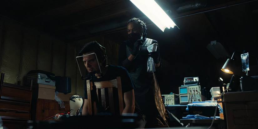 Reghabi holding a needle above Mark in an operating chair in Severance season 2, episode 6 (2025)