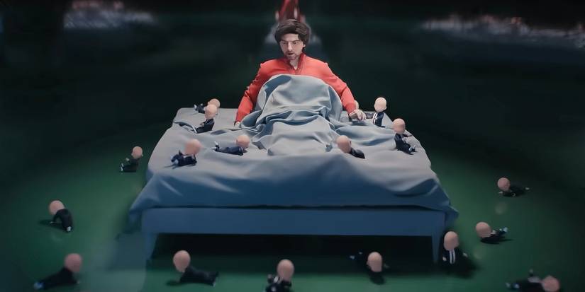 Mark in bed surrounded by babies in the opening sequence of Severance season 2