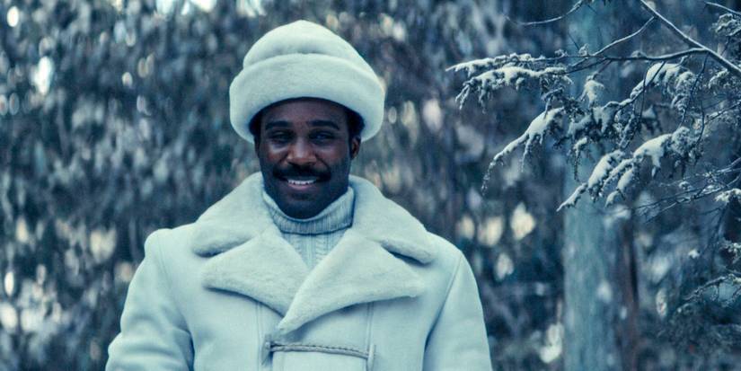 Milchick (Tramell Tillman) wearing a white coat and hat in a snowy forest in Severance Season 2 Ep 4