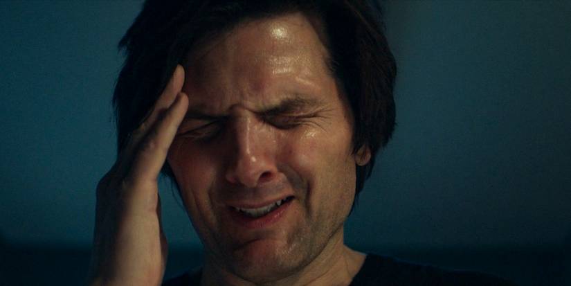 Mark (Adam Scott) experiences a severe headache after his procedure in Severance Season 2 Ep 6